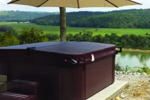 Hot tub with large umbrella overlooking river