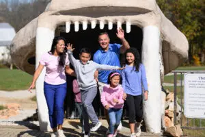 Family at the entrance of the Cavern of the Sabertooth at Indiana Caverns