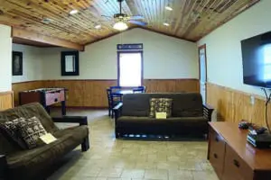 Game room with TV, couches, and foosball table