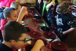Middle school kids dipping candles at Squire Boone Caverns