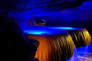 Rimstone dam with blue lights creating a stunning effect at Squire Boone Caverns