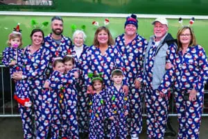 3 generations of family dressed in pajamas as they are about to board the Polar Express Train Ride