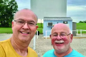 Owner Steve Wilson with guest in front of the movie screen.