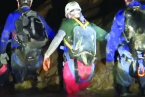 Deep Darkness exploreing tour group walks through the underground river