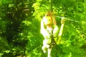 Someone ziplining through trees at SBC Zipline Adventure