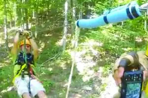 Guy approaching the landing platform after a zipline trip at SBC Zipline Adventure
