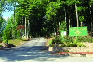Entrance to Syscamore Springs with lush green grees