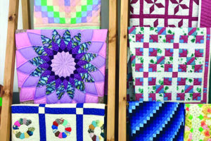 Quilts over rack at Martin's Market
