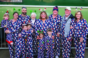 3 generations of family dressed in pajamas as they are about to board the Polar Express Train Ride