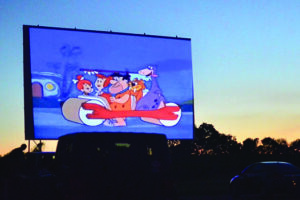 The Flintstones cartoon on the drive in movie screen