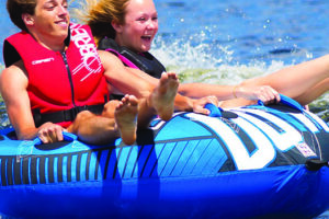 Two teens having fun adventure tubing on Patoka Lake