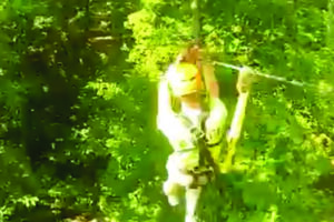 Someone ziplining through trees at SBC Zipline Adventure