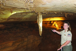 DNR cave guide pointing out cave formation